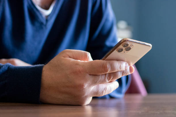 istock Closeup shot of an unrecognizable man using a cellphone in an office 1454873658