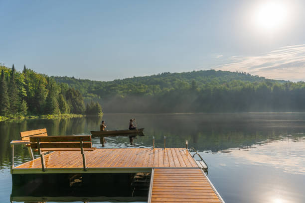 istock Couple canoeing in early morning. 1454875044