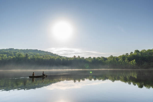 istock Couple canoeing in early morning. 1454875053
