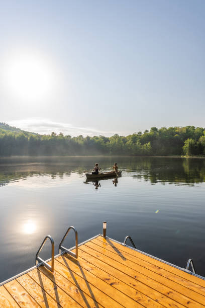 couple canoeing in early morning. - foto’s van oudere mannen stockfoto's en -beelden