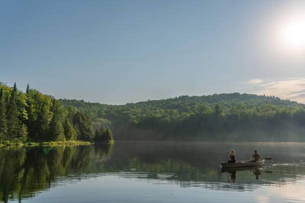 Couple canoeing in early morning.