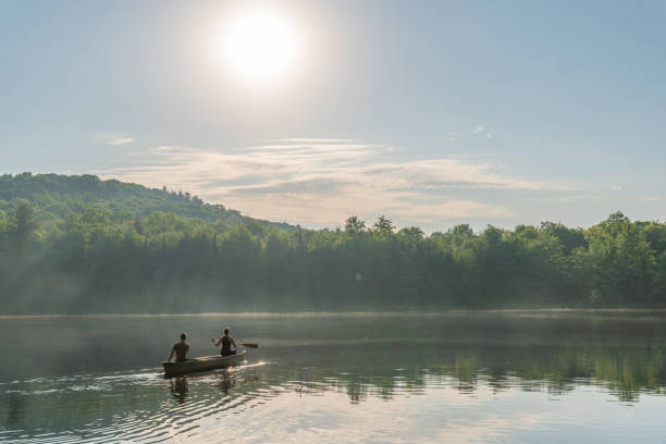 istock Couple canoeing in early morning. 1454875082