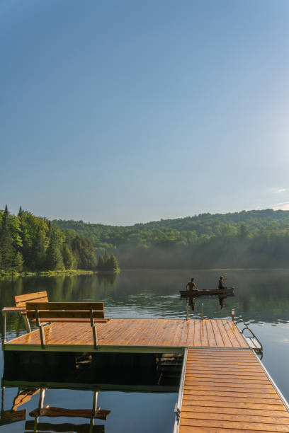 istock Couple canoeing in early morning. 1454875092