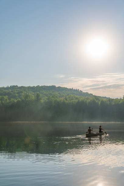 istock Couple canoeing in early morning. 1454875105