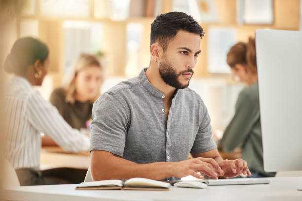 istock Focus business man typing computer in digital marketing agency on planning, email and internet analytics on technology in office. Young web designer working on desktop pc for creative startup project 1454875436