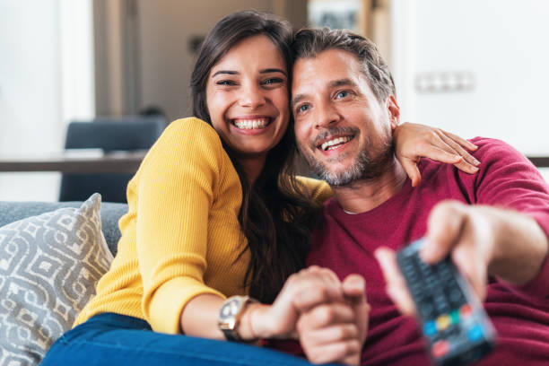 Happy couple watching tv