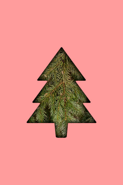istock christmass tree shape cut in the colorful surface, creative holidays concept 1454877045