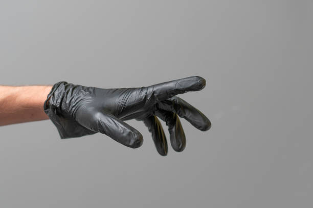 human palm wearing black latex glove isolated