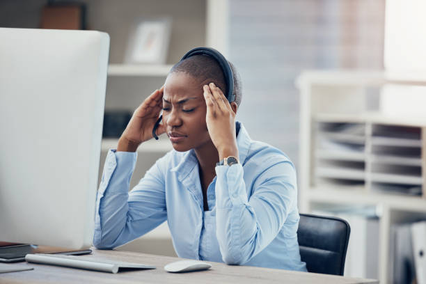istock Black woman headache, call center stress and burnout, computer 404 fail glitch and receptionist pain at sales agency office desk. Angry, frustrated and anxiety consultant worker, problem and mistake 1454880684