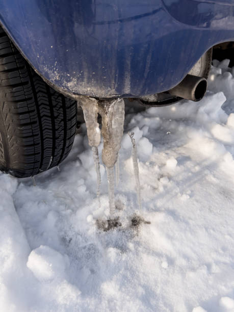 istock Snow under the wheels and icicles on the bumper. 1454880879