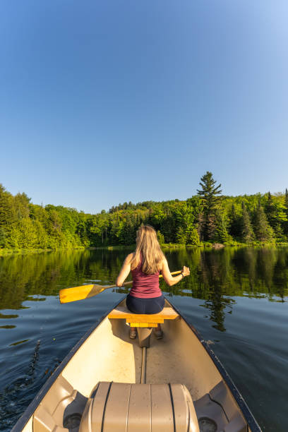 istock A woman canoeing in early morning. 1454881142
