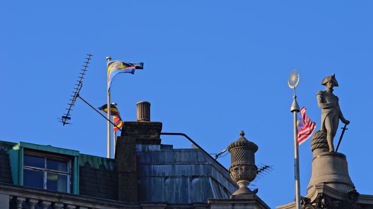 The big national flag of Malaysia flying in the wind, in the sun, in Trafalgar Square in London. Stripes of Glory. Jalur Gemilang. Slow Motion. Version 2