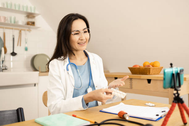 istock Asian doctor making an online podcast 1454883704
