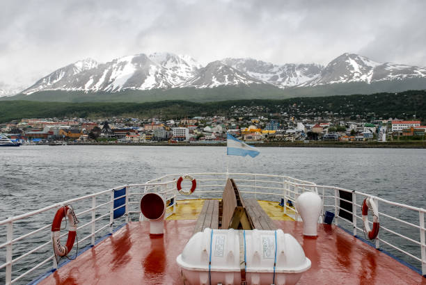 Snow capped mountains above Ushuaia Ushuaia, Argentina - nov 15, 2006: panorama of Ushuaia seen from the Beagle Channel in stormy weather beagle channel stock pictures, royalty-free photos & images