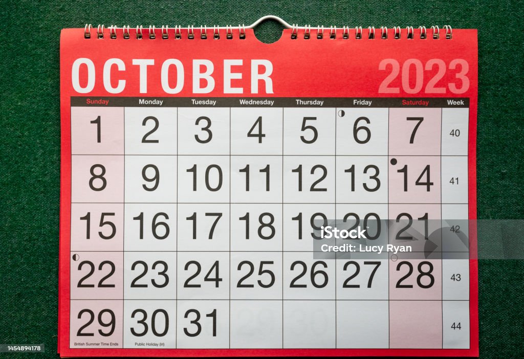 Calendar 2023, October, monthly planner for wall and desk with large boxes for each date. Calendar 2023, October, monthly planner. Day, month, year, date and activity organiser wall and desk planner. Red and white calendar with large letters and numbers on green background. Shown at angle. 2023 Stock Photo