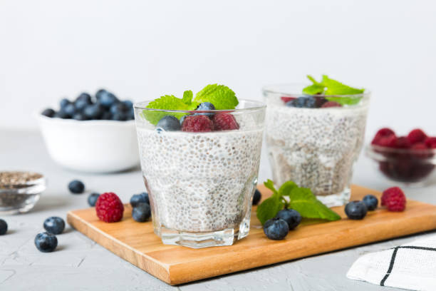 istock Healthy breakfast or morning with chia seeds vanilla pudding raspberry and blueberry berries on table background, vegetarian food, diet and health concept. Chia pudding with raspberry and blueberry 1454894351