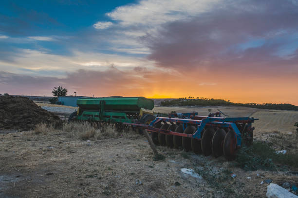 image of farmer machinery in the field stock photo