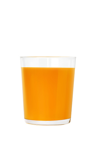 Front view of  a single drinking glass full of orange juice beside a sliced orange isolated on white background