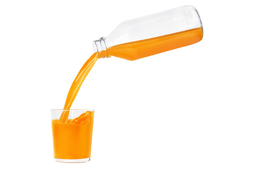 Close-up of slice of orange falling into a glass of juice against white background.