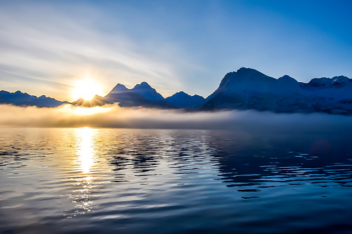 The sun in just beginning to rise in Valdez, Alaska. Looking out across Prince William Sound, the late morning sunrise created a stunning scene.