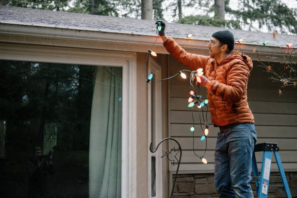 istock Man Working on Home Christmas Lights 1454901226