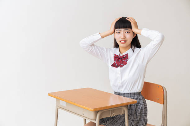 istock girl who study,think,School uniform,School classroom 1454902932