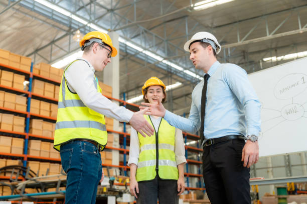 istock Group of industry workers stacks hands to motivation 1454909769