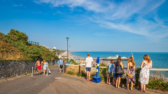 Bournemouth, United Kingdom-August 13 2022 : People looking towards  Bournemouth Beach and Pier in Dorset England UK