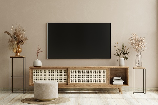 Smart TV on the cream color wall in living room,minimal design.3d rendering