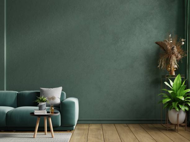 istock Mockup living room interior with green sofa on empty dark green wall background. 1454911061