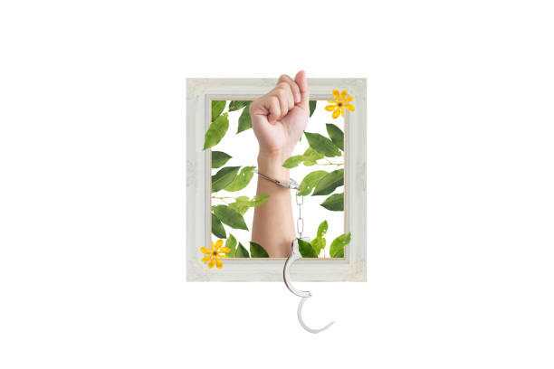 istock Digital collage modern art. Hand raised with handcuff and leaves, flowers 1454914830