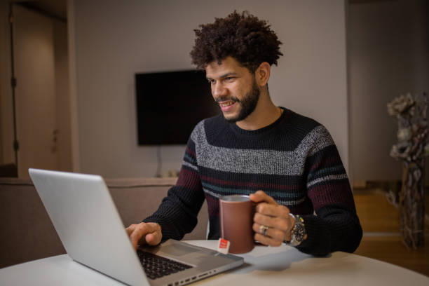 istock Young fashionable man working at home 1454915388