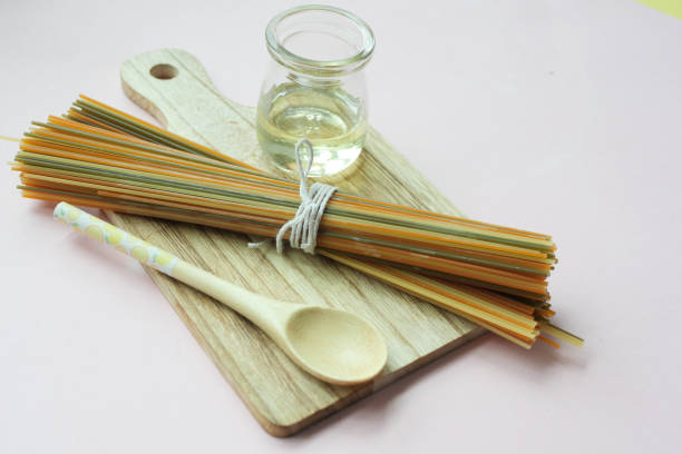 istock Yellow long spaghetti egg and oil on table 1454917899