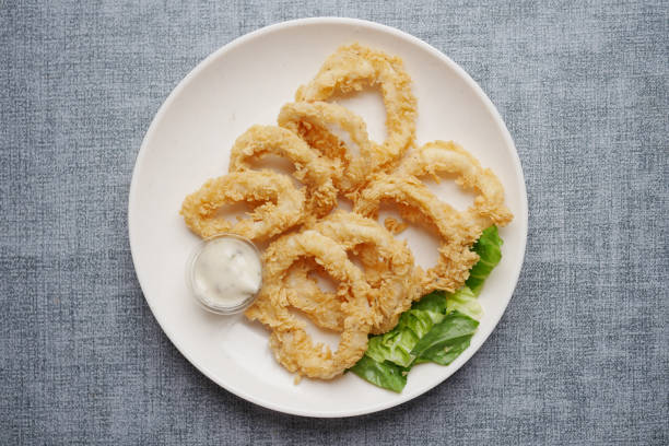 istock cooked squid rings and shrimp on a plate top view 1454919257