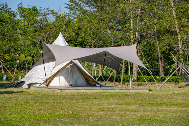 istock Camping tents on the park grass under a clear sky 1454925162