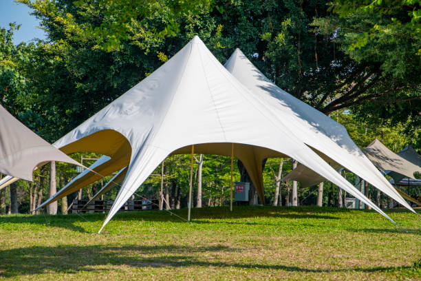 istock Camping tents on the park grass under a clear sky 1454925190