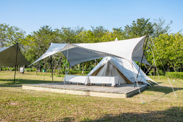 istock Camping tents on the park grass under a clear sky 1454925544