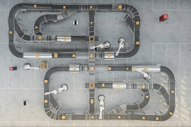 high angle view of robotic arms working on conveyor belt in smart warehouse - driverless train imagens e fotografias de stock