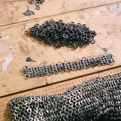 Manufacture of medieval armor and chain mail to protect soldiers in battle. Reconstruction of the events of the Middle Ages in Europe.