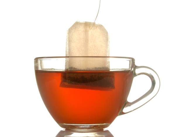 istock glass cup with tea and tea bag close up on white isolated background 1454927690
