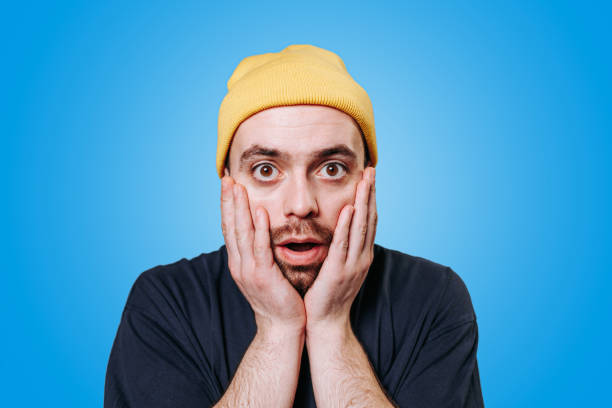 istock Shocked stunned People sincere emotions, on blue background, studio shot. 1454927867