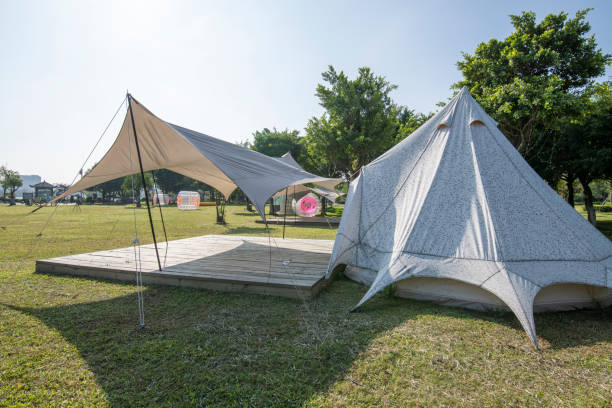 istock Camping tents on the park grass under a clear sky 1454929004