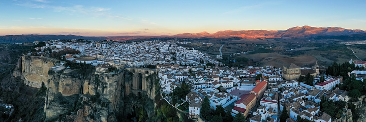 Rocky landscape of Ronda city with Puente Nuevo Bridge and buildings, Andalusia, Spain