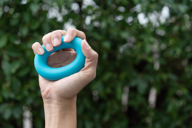 istock Hands of a man squeezing a blue stress ball. 1454930666