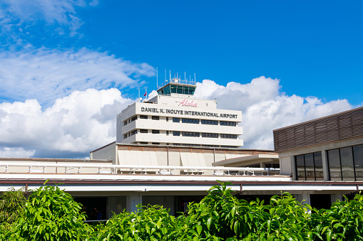 Daniel K. Inouye International Airport sign on building tower facade of HNL Honolulu International Airport. - Honolulu, Hawaii, USA - 2022