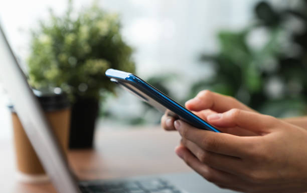 istock Hand holding smartphone with using social media on internet. 1454937256