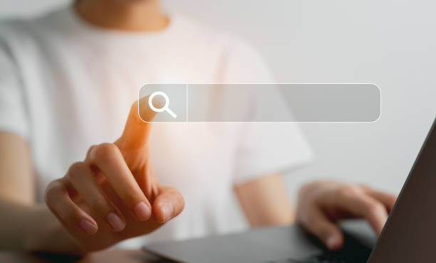 istock Hand clicking search bar, Searching information on internet. 1454937334