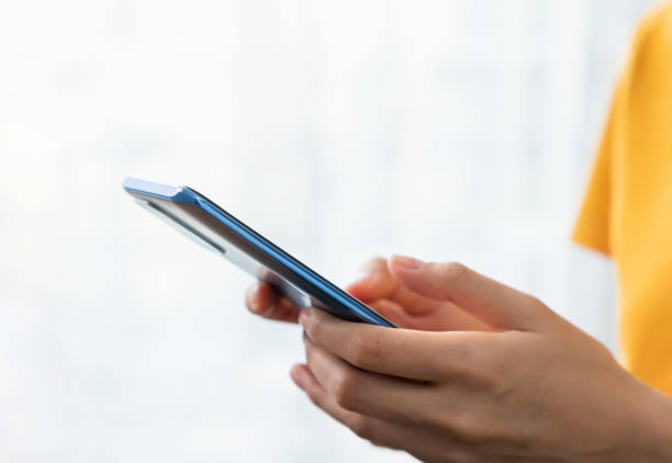 istock Hand holding smartphone with using social media on internet. 1454937349