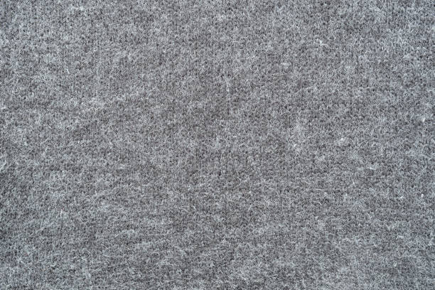 istock Texture of gray woolen knitted fabric. Grey wool knit cloth background. Knitted pattern 1454939017