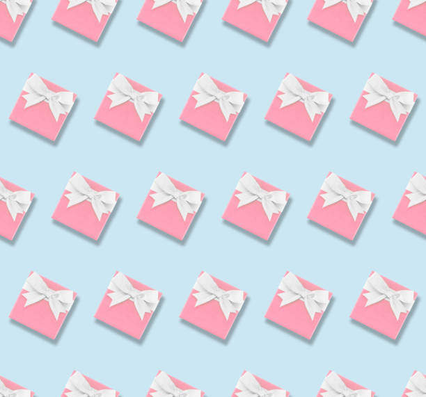 istock seamless pattern of pastel pink gift box with white ribbon bow on pastel blue background 1454945318